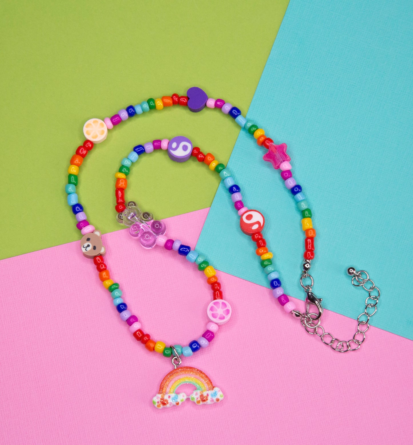 A different angle showing the rainbow teddy bear necklace 