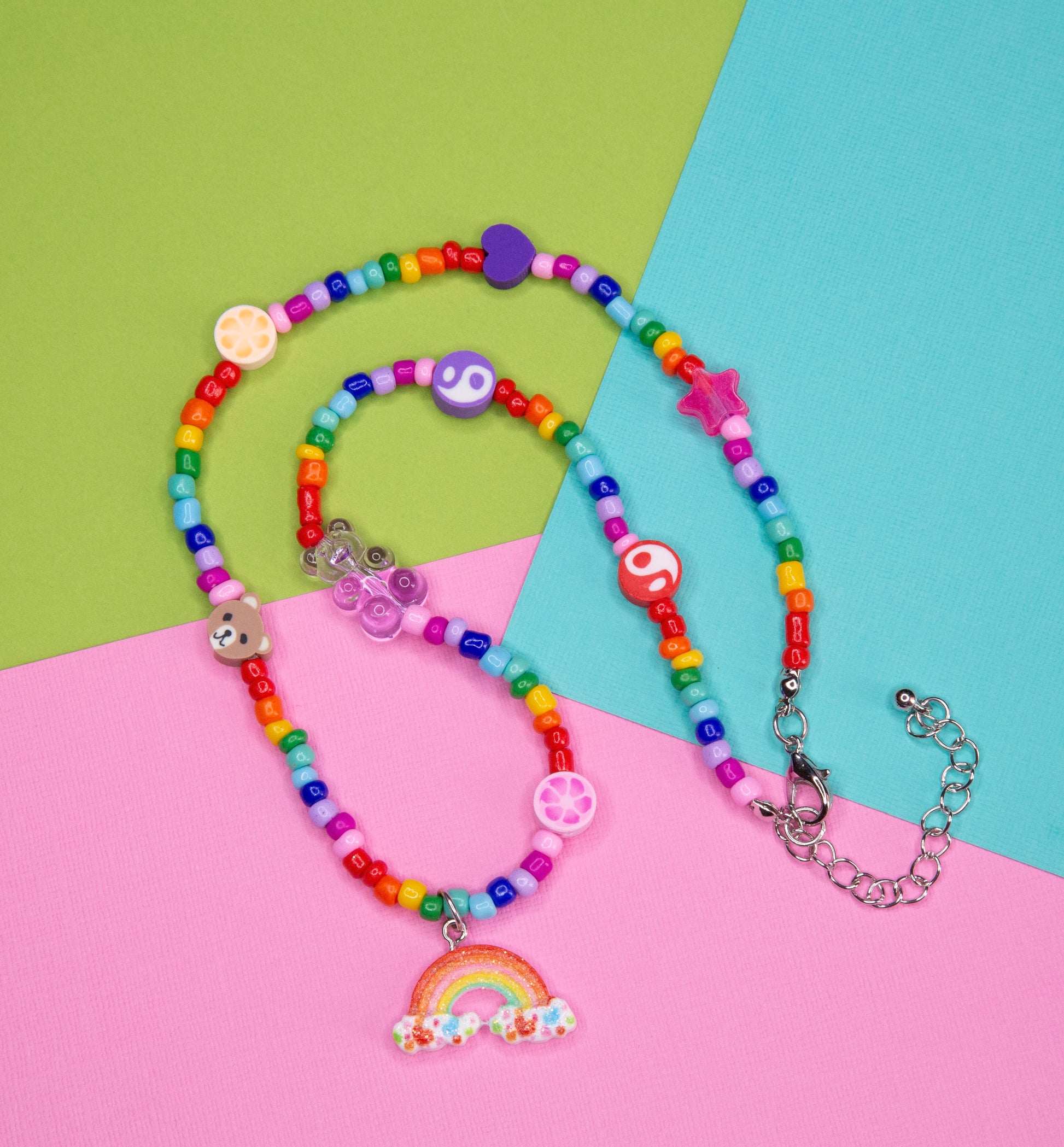 A different angle showing the rainbow teddy bear necklace