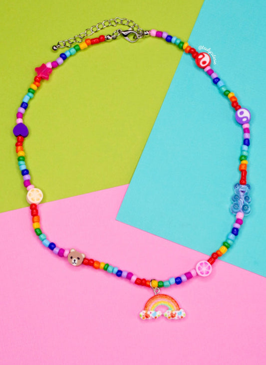 This pretty handmade rainbow teddy necklace is made from polymer clay beads and a vibrant array of colour beads. It’s the perfect accessory to jazz up any outfit.    Colours of clay beads like the teddy bears may differ. Made with colourful seed beads.